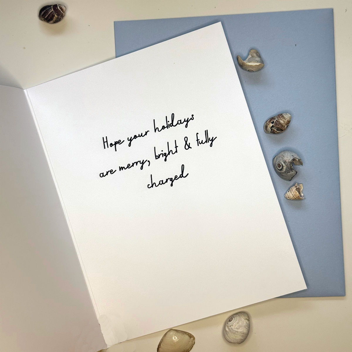 Inside of Feeling Eel-lectric Christmas card reading Hope your holidays are merry bright and fully charged