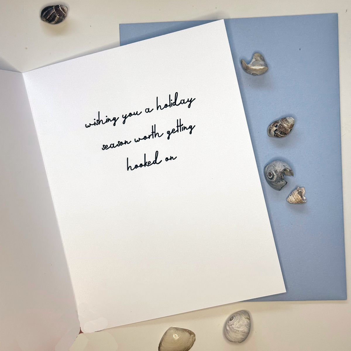 Inside of Hooked on the Holidays pufferfish Christmas card reading wishing you a holiday season worth getting hooked on