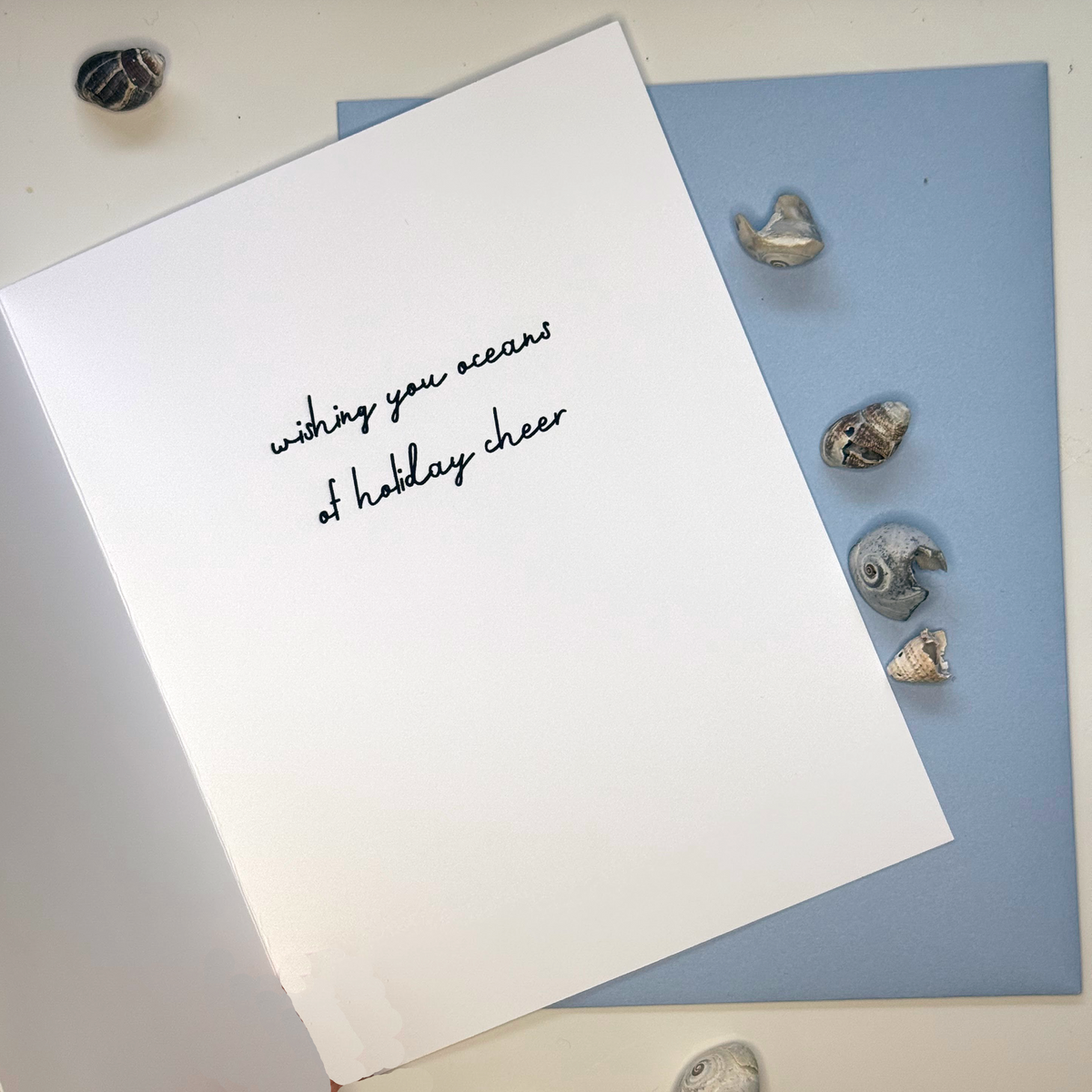 Inside of Festive as Shell mussel Christmas card reading wishing you oceans of holiday cheer