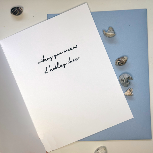 Inside of Festive as Shell mussel Christmas card reading wishing you oceans of holiday cheer