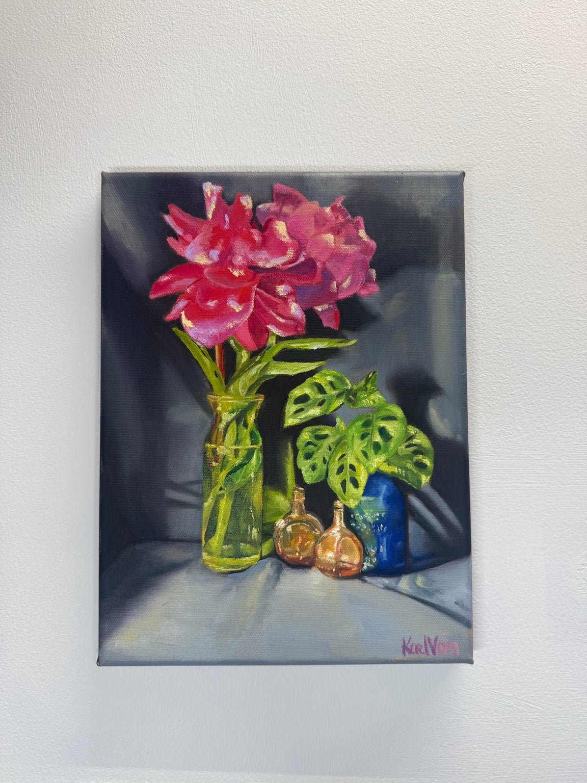 Original 9 by 12 oil painting by Kael Von with pink flowers, monstera leaves, glass bottles and a blue pot