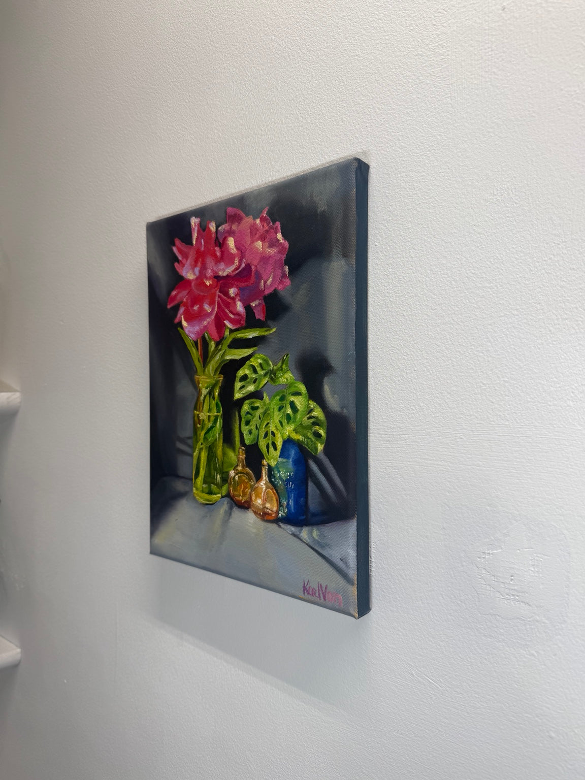 Angled side view of pink floral oil painting on duck cotton canvas